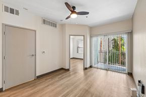 Las Vegas apartment for rent - A room with a ceiling fan and sliding glass doors.