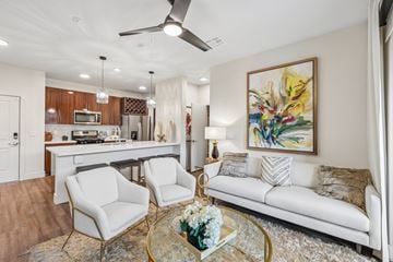 Las Vegas apartment for rent - A living room with a white couch, a coffee table, and a painting on the wall.