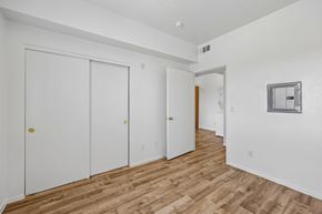 Las Vegas apartment for rent - A room with white walls and wooden flooring with two white doors.