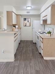 Sparks apartment for rent - A kitchen with white appliances and wooden cabinets.