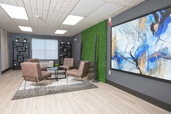 An image of a lobby with chairs and a large screen
