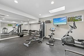 Hoover apartment for rent - A spacious gym with a variety of equipment including treadmills, stationary bikes, and weight machines.