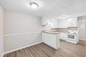 Hoover apartment for rent - A kitchen with white cabinets and a white island.