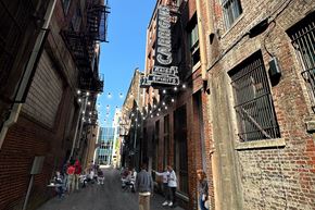 Birmingham apartment for rent - A narrow alley with people walking down it and a sign that says "Crafts".