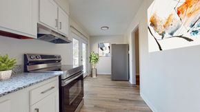 Birmingham apartment for rent - A kitchen with a stove top oven and a refrigerator.