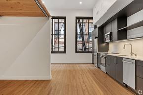 Birmingham apartment for rent - A kitchen with wooden floors and a white wall.