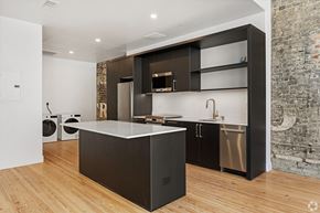 Birmingham apartment for rent - A modern kitchen with a large island and dark wood cabinets.