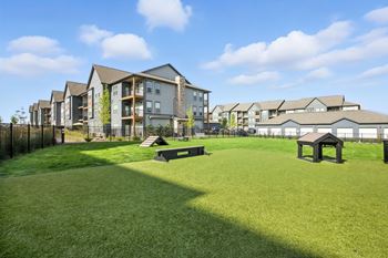 A grassy area in front of apartment buildings