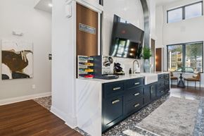Pooler apartment for rent - A modern kitchen with dark wood cabinets and a white countertop.at The Liliana Apartment Homes, Pooler Georgia