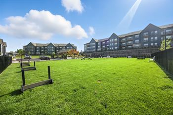 A grassy area in front of apartment buildings