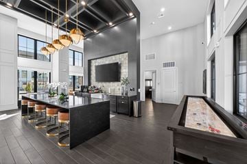 Fort Collins apartment for rent - A billiard table is in the middle of a modern kitchen and dining room.