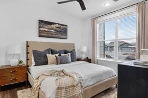 Nampa apartment for rent - A bedroom with a large bed and a painting on the wall.at The Logan Luxury Apartments, Nampa, ID, 83651
