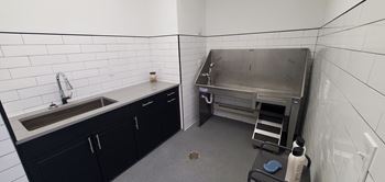 A kitchen with a sink and a stove in it