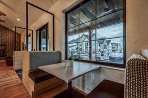 Wyoming townhouse for rent - a dining room with a large window and a table at The BLVD at Wilson Crossings, Michigan, 49418