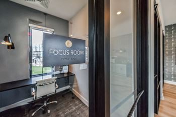 A focus room with a desk and a sign on the door