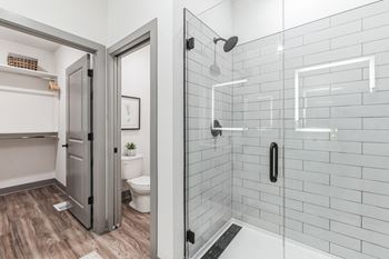 A white bathroom with a shower and a toilet