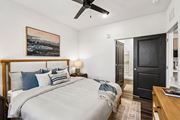 Ponte Vedra Beach apartment for rent - A bedroom with a large bed and a ceiling fan.
