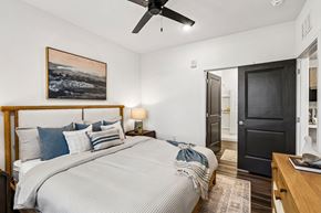 Ponte Vedra Beach apartment for rent - Bedroom with wood bed frame and open bathroom door at Velara Luxury Apartments, Ponte Vedra Beach, 32081