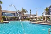 Ponte Vedra Beach apartment for rent - A large swimming pool with a fountain in the middle of it.