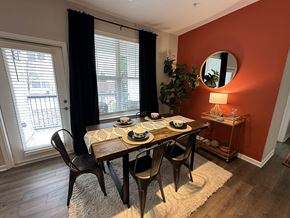 Fayetteville apartment for rent - a dining room with an orange wall and a table and chairs at Watermark at Steele Crossing, Arkansas, 72703