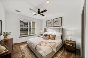 Wyoming townhouse for rent - a bedroom with a large bed and a ceiling fan at The BLVD at Wilson Crossings, Wyoming