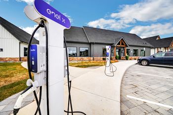 An electric car charging station in front of a house