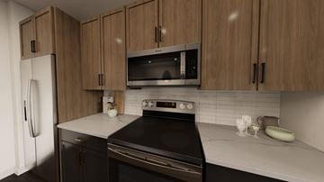 Gilbert apartment for rent - A kitchen with wooden cabinets and a black stove top oven.