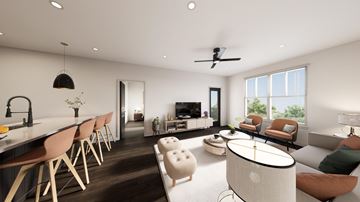 Colorado Springs apartment for rent - A modern living room with a long wooden dining table and chairs, a white sofa, and a round coffee table.