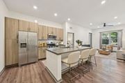Sarasota apartment for rent - A modern kitchen with wooden cabinets and a white island at The Concord Luxury Apartments, Sarasota, Florida