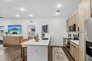 Ponte Vedra Beach apartment for rent - A modern kitchen with wooden cabinets and a white island.