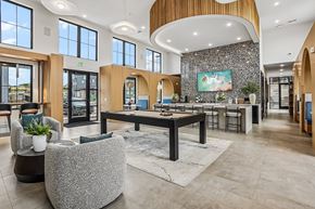 Colorado Springs apartment for rent - A spacious lobby with a reception desk and a large painting on the wall.