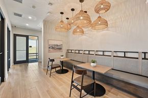 Sarasota apartment for rent - A modern dining area with a long table and chairs at The Concord Luxury Apartments, Sarasota, FL, 34240