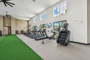 North Port triplex for rent - A gym with treadmills, exercise bikes, and a green carpet at The Hadley - North Port, FL Apartments, North Port, FL, 34287