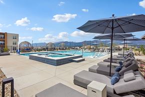 Colorado Springs apartment for rent - A pool area with sun loungers and umbrellas.