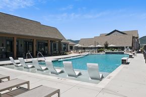 Monument apartment for rent - A pool with chairs and a building in the background at Alta25, Monument, 80132