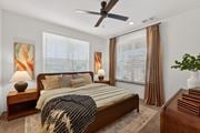 Phoenix apartment for rent - A bedroom with a bed, nightstands, and a ceiling fan.at Refinery at Pointe17 Apartments, Phoenix, AZ, 85085
