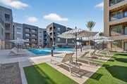 Phoenix apartment for rent - A sunny day at the pool with chairs and umbrellas.