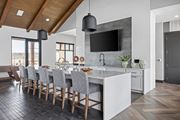 Monument apartment for rent - a kitchen with a marble counter top and a long island with chairs at Alta25, Monument
