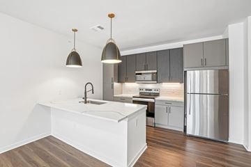 Fort Collins apartment for rent - A modern kitchen with a white island and stainless steel appliances.