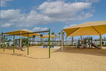 Shaded playground with swings and slides