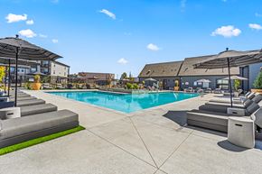 Nampa apartment for rent - A large outdoor swimming pool with steps leading down to the water.