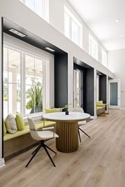 Ellenton apartment for rent - a dining room with a table and chairs in front of a large window at Palm Grove in Ellenton, FL 34222