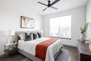 Ellenton apartment for rent - a bedroom with a bed and a ceiling fan at Palm Grove in Ellenton, FL 34222