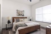Sarasota apartment for rent - A bedroom with a large bed and a painting on the wall.