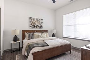Sarasota apartment for rent - A bedroom with a large bed and a painting on the wall.