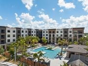 Sarasota apartment for rent - A large swimming pool is surrounded by apartment buildings.