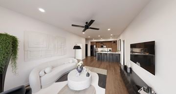 Newnan apartment for rent - A modern living room with a white sofa and a coffee table.