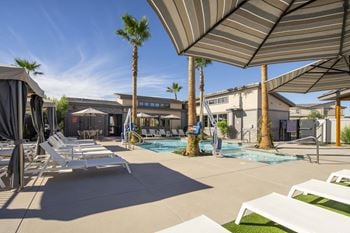 A pool with lounge chairs 