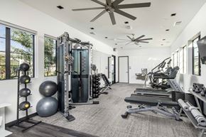 Peoria triplex for rent - a gym with weights and a ceiling fan at Grandstone at Sunrise, Peoria, AZ