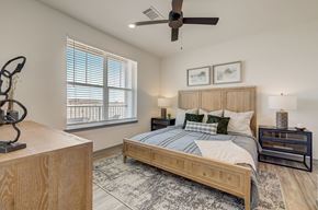 Monument apartment for rent - a bedroom with a bed and a ceiling fan at Alta25, Monument, Colorado